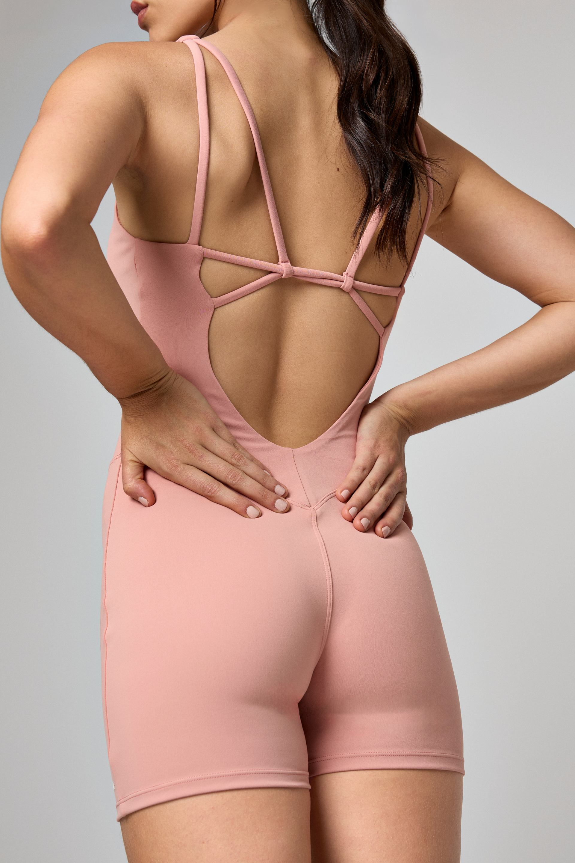 Lane Jumpsuit in Grapefruit Pink, back view, ÔNNE activewear